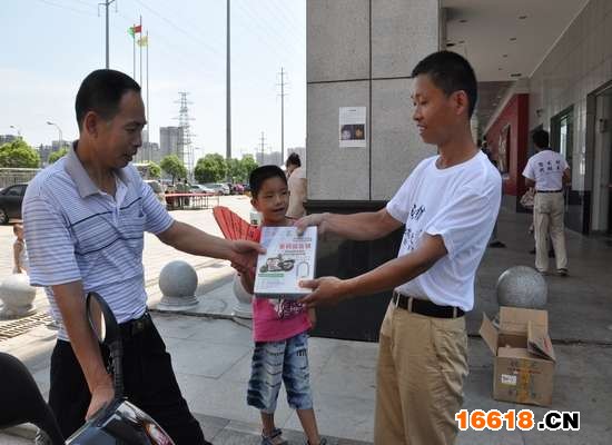 7月3日，一市民从谢军手上接过密码防盗锁试用 记者 蒋小康 摄